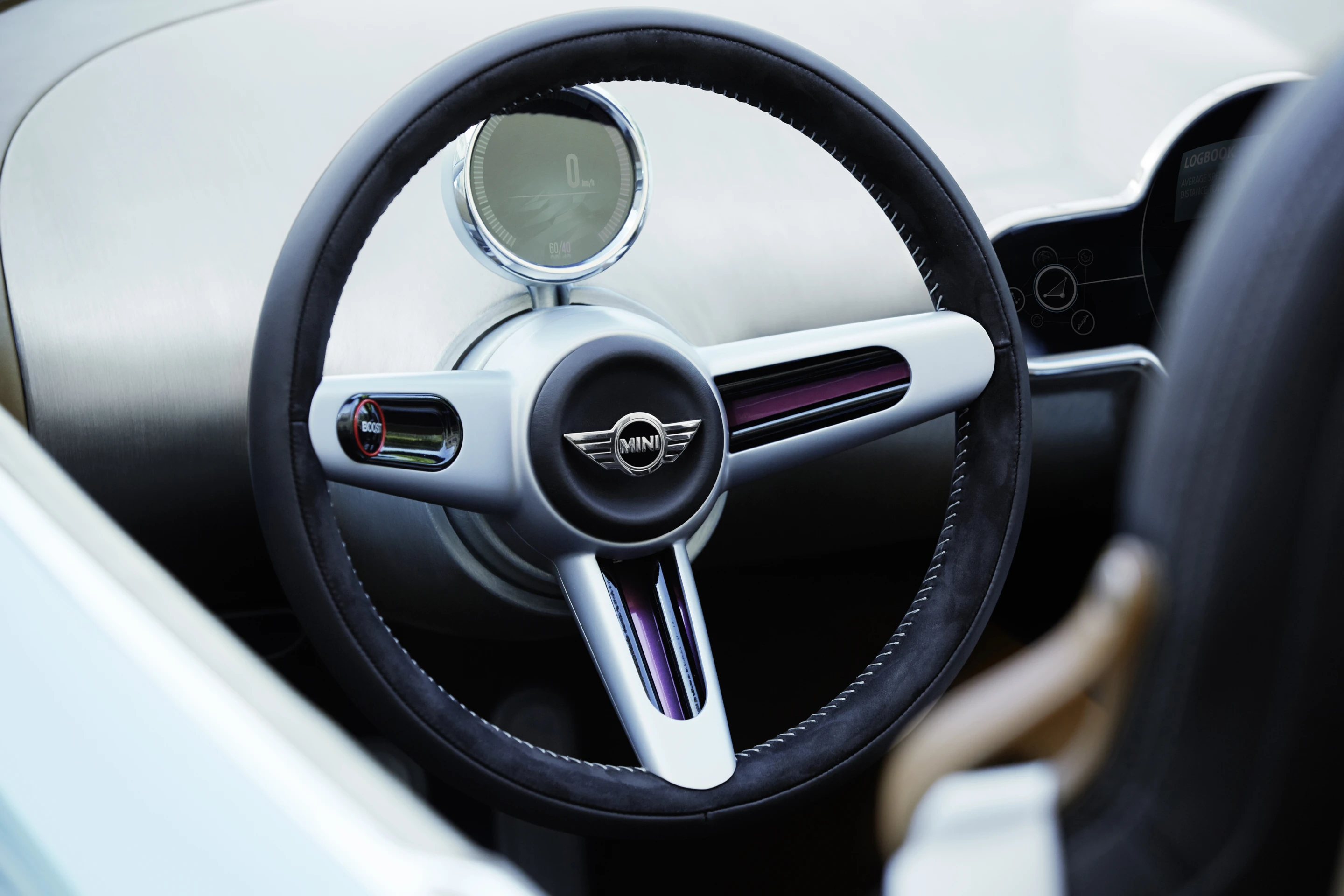 The speedometer sits by itself on the steering column, while the modified centralized instrument cluster features an analog clock and an interactive digital element