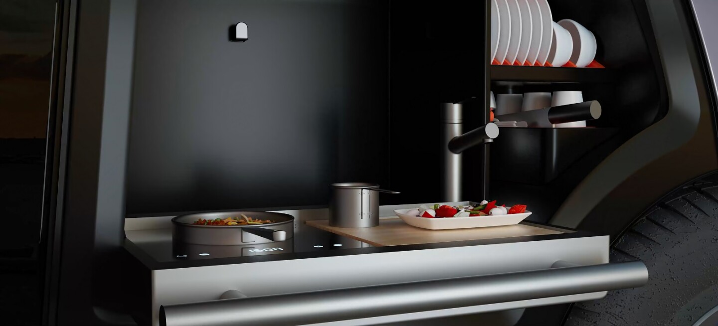 A pull-up panel to the side reveals a built-in kitchen block for roadside meals