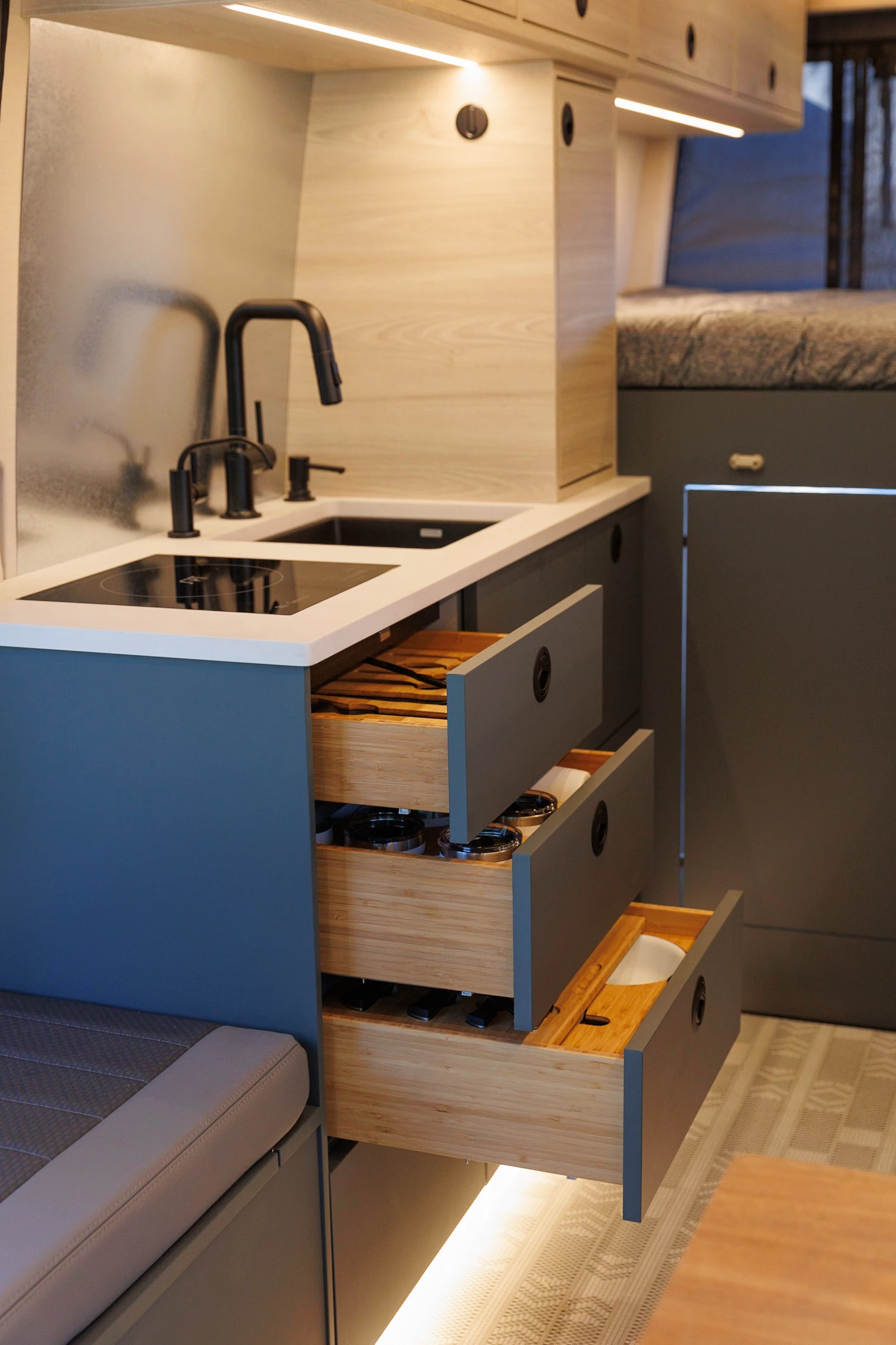 The Deso kitchen has an induction cooktop, sink with filtered water faucet, microwave and fridge