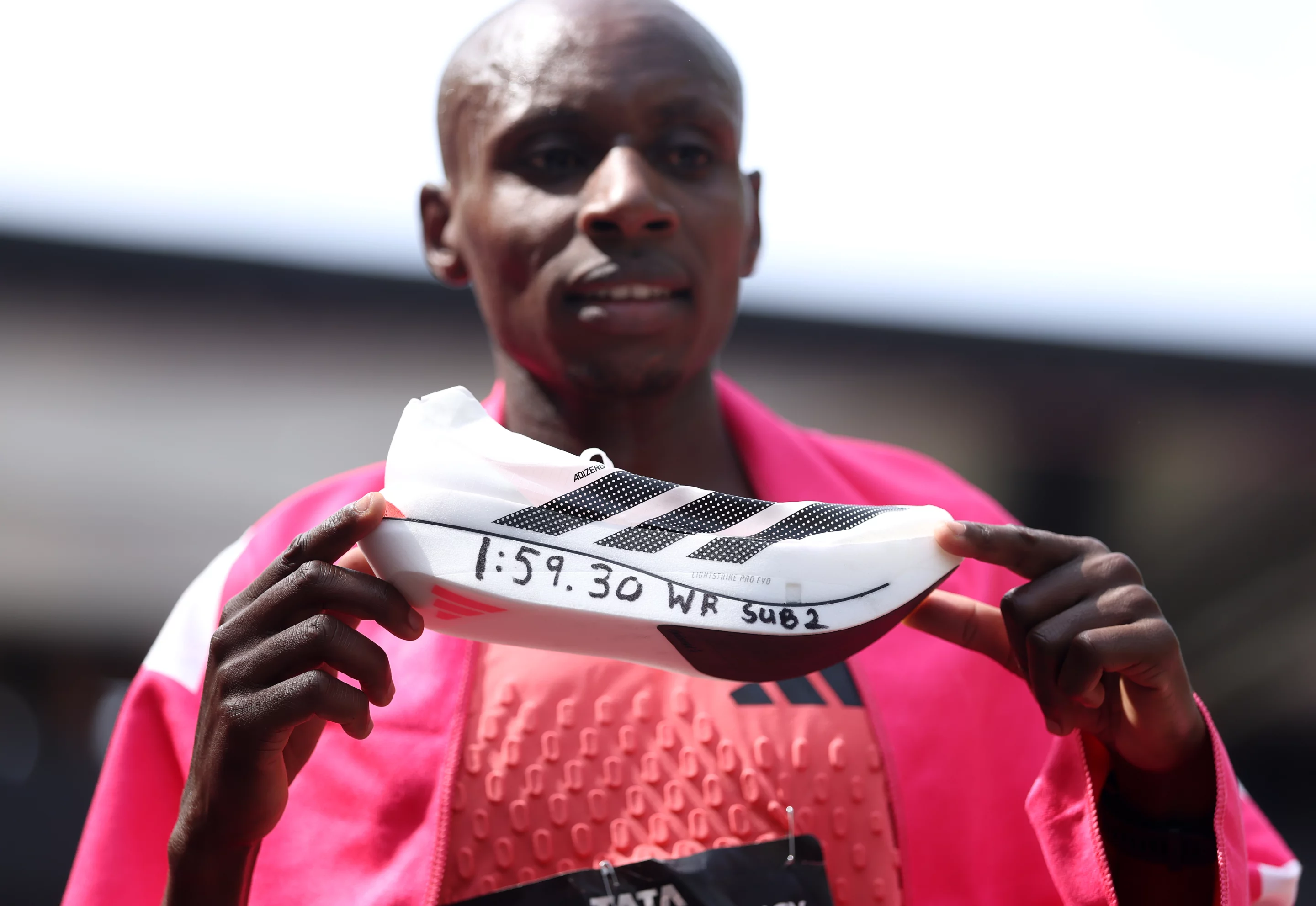 Sabastian Sawe of Team Kenya celebrates with his Adidas "super shoe"