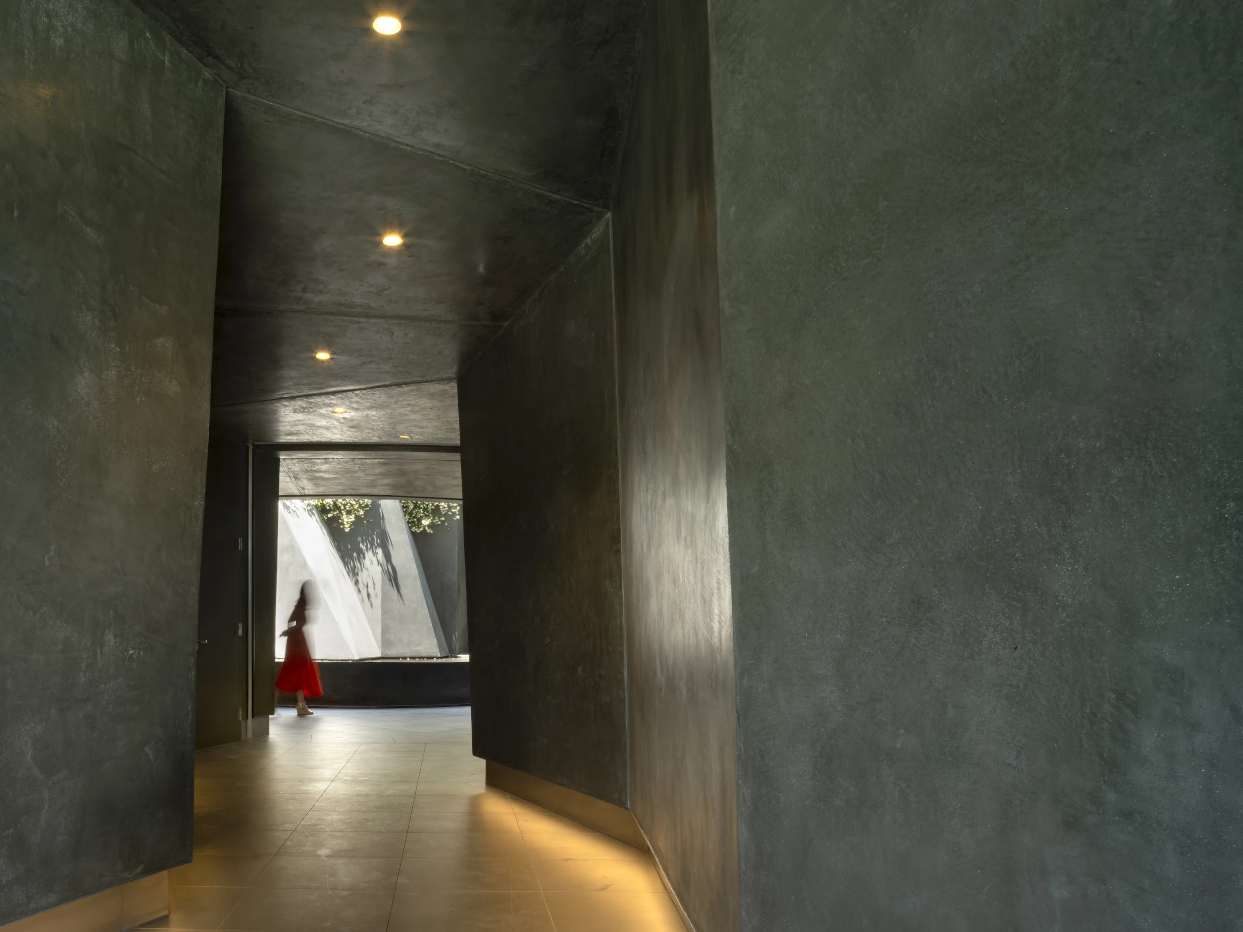 "The entrance adopts the atmosphere of a cave digging into the hillside; a dim, surreal environment where residents are led on a journey through a fairyland' of light, shadow, and the sound of water,"