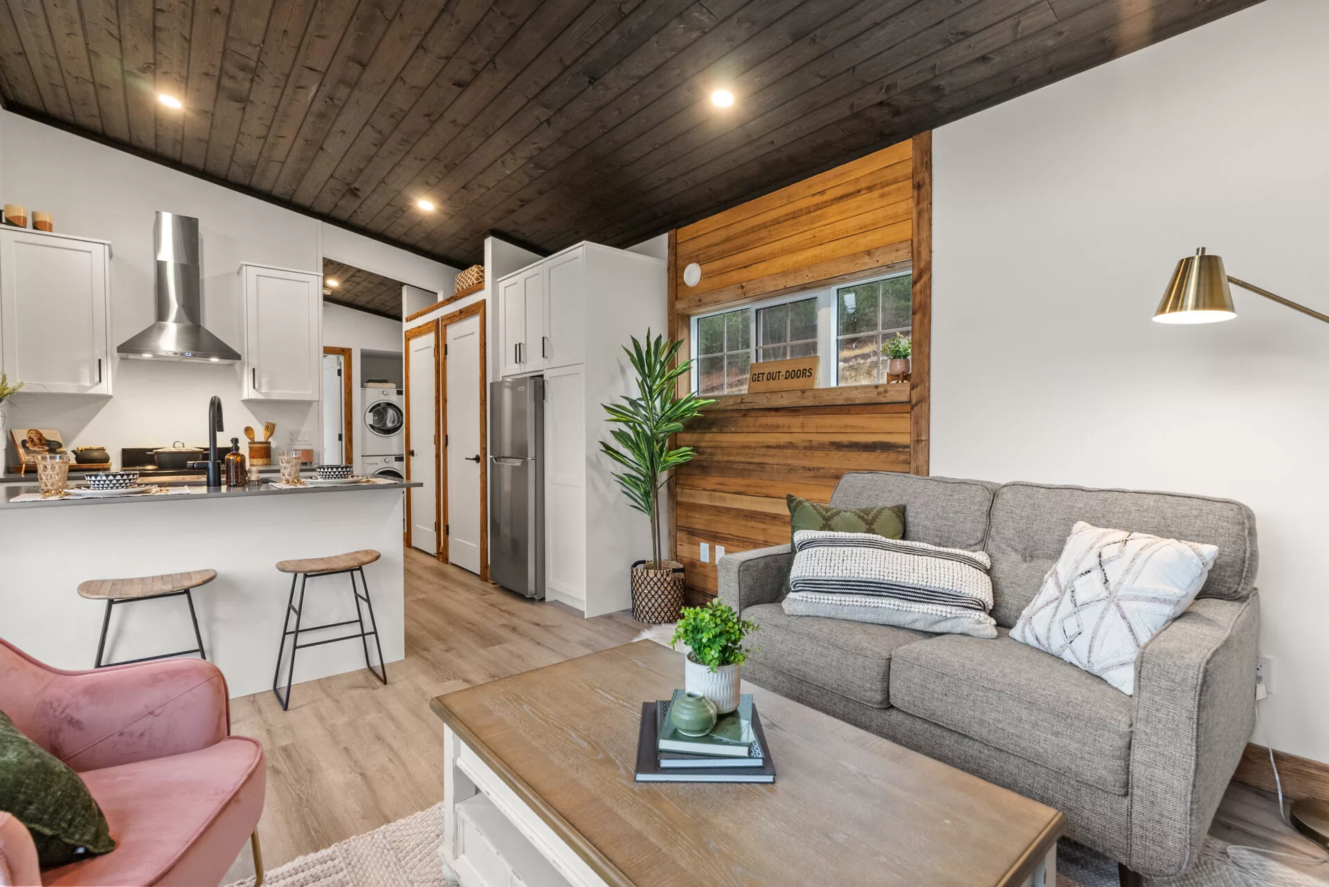 The Silvertip's living room is large and includes an electric fireplace, a sofa, and seating