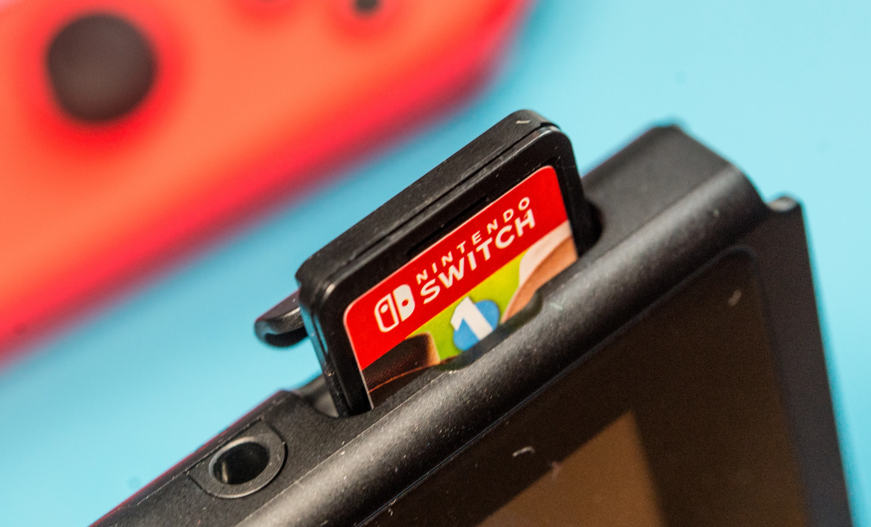 A game cartridge sticking out of the Nintendo Switch
