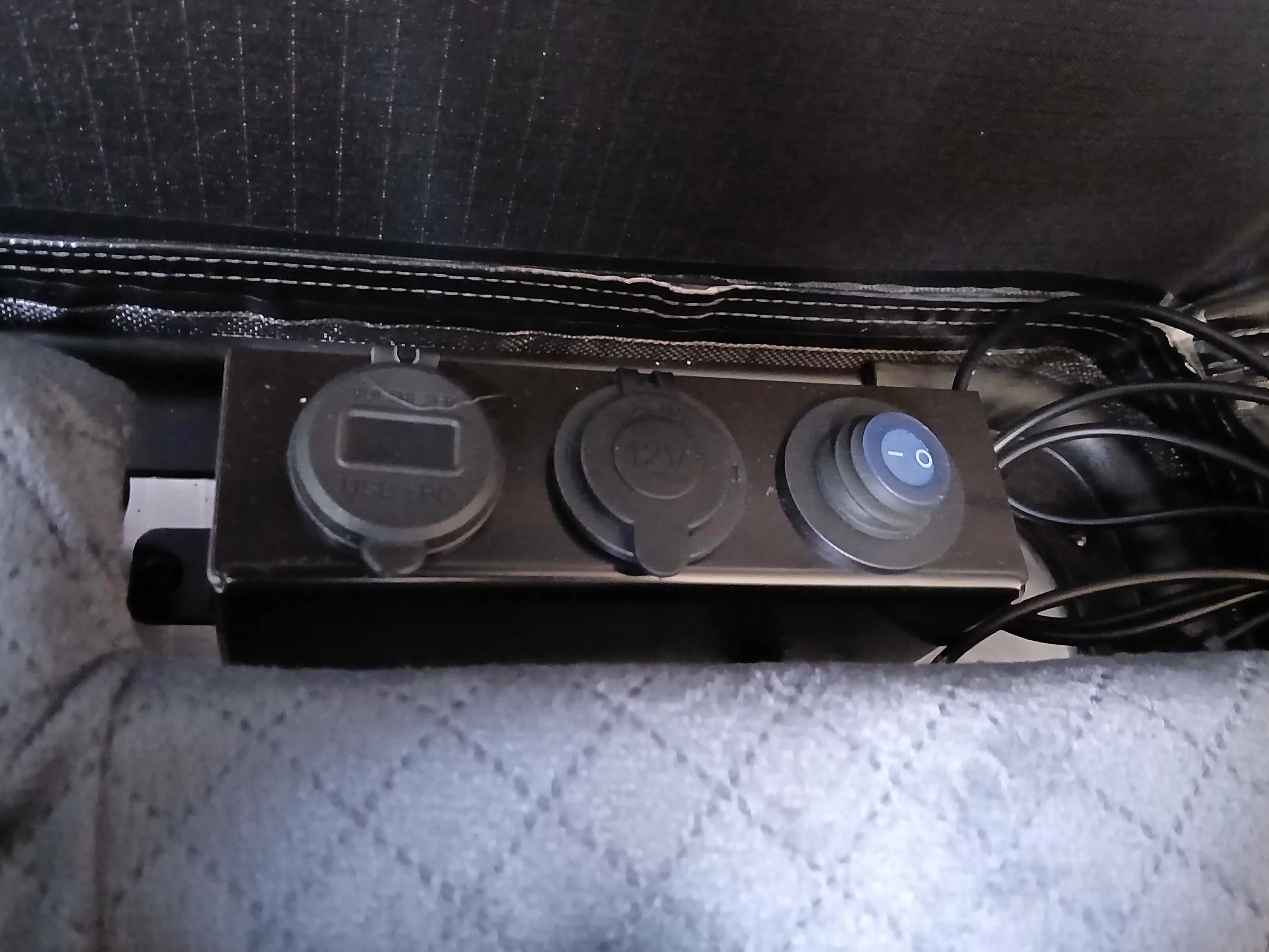 The battery hookup on the underside of the tent powers the outlets in this little strip, and the wire runs to the overhead LED strip