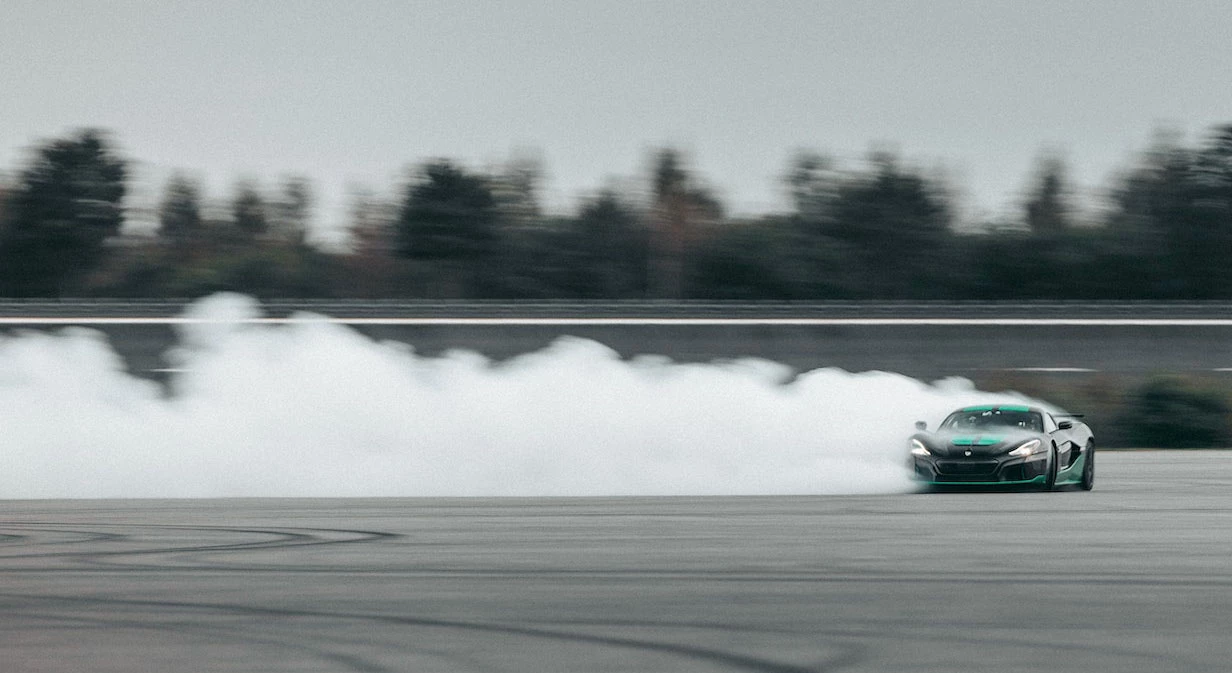 Test driver Goran Drndak celebrates the new record with a ribald powerslide
