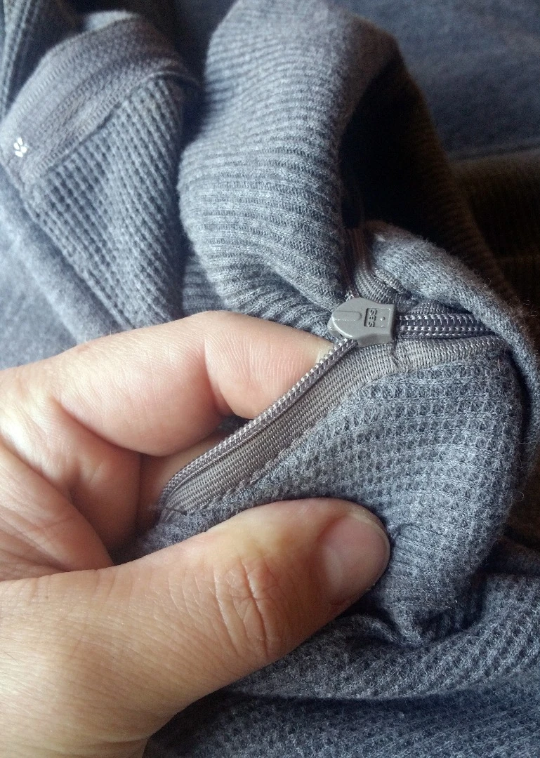 Turned inside out, one hand pocket of the Ravean heated hoodie shows a well-attached zipper