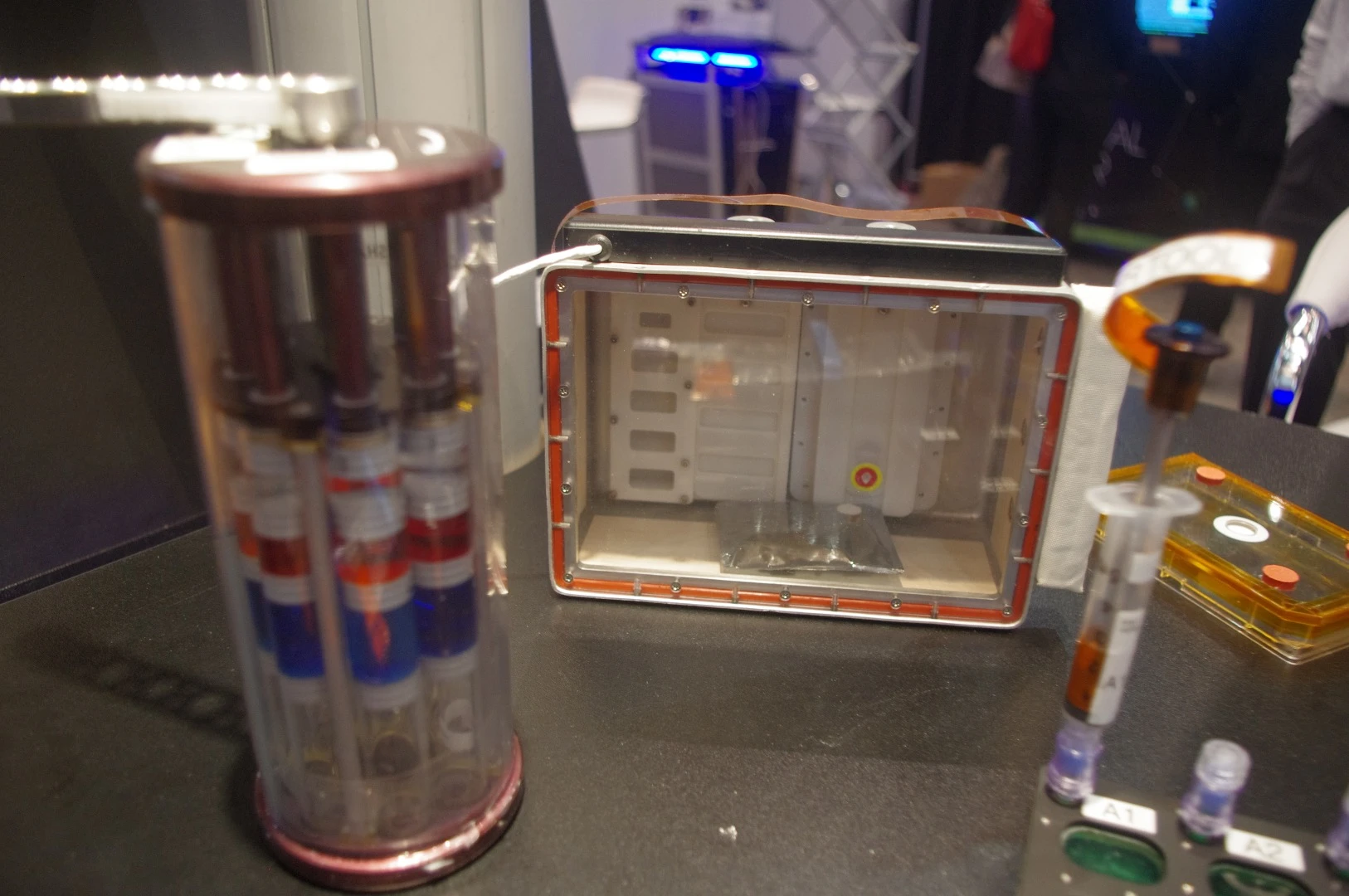 On the left side is a device that's used to mix bacteria with growth mediums in the microgravity environment of the ISS. Zea said that the benefit to experimenting on bacteria is space derives from the fact that the bugs tend to be more virulent in microgravity, so researchers could find genes being expressed in space that might not be seen on Earth and develop novel treatments to combat them. The box on the right is used to send various critters to space, such as ladybugs and butterflies. Zea said that a jumping spider was sent up and it was observed that the arachnid had to adapt to weightlessness in order to attack its prey, as its usual parabolic arc was disturbed aboard the ISS.
