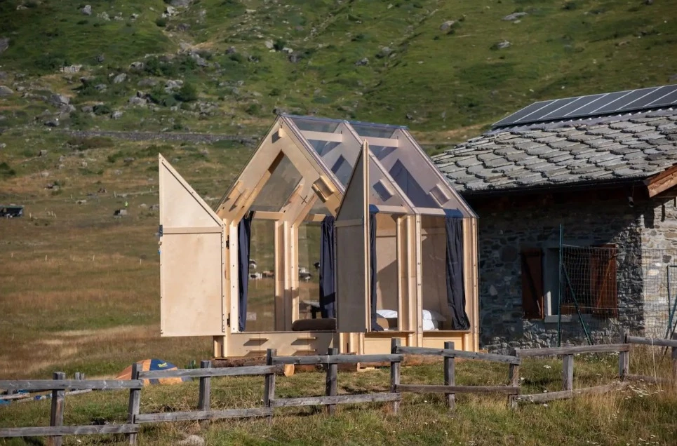 Two large front doors open outwards, allowing guests to enjoy the natural surroundings