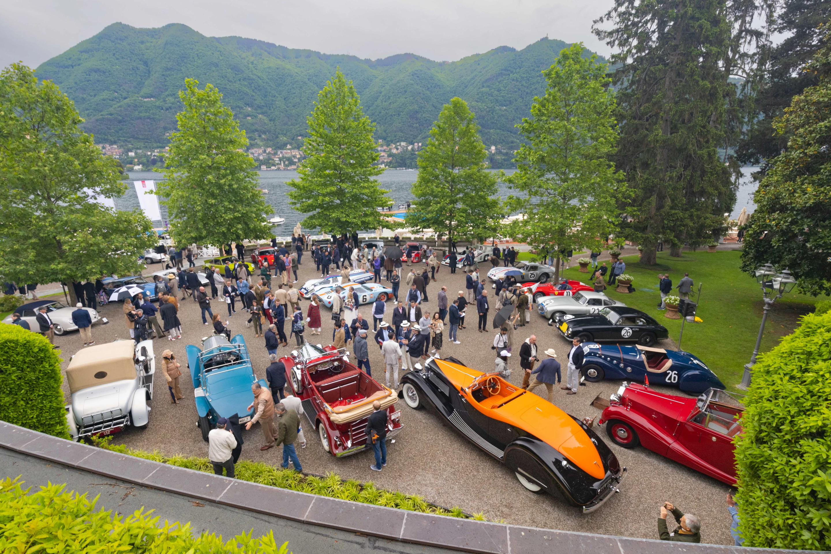 The monumental size of the Duesenberg SJ Speedster can be seen in perspective with the cars around it in this image.