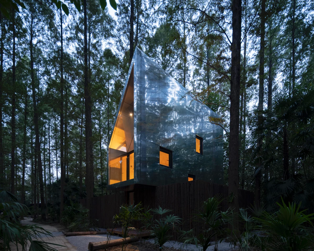 This treehouse rises quietly among the trees at Wiki World–Secret Camp
