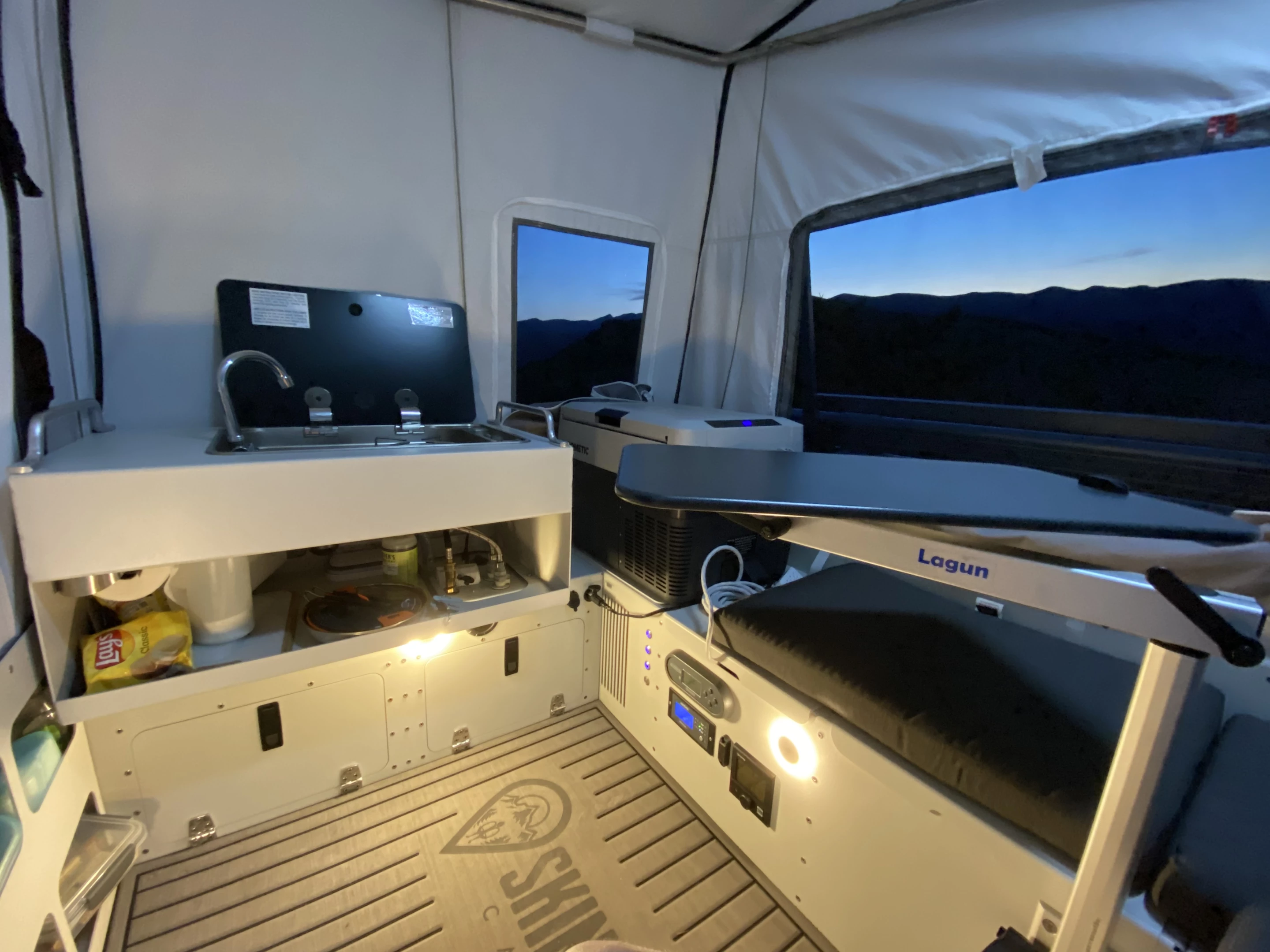 With a little thought and organization, Skinny Guy creates a full kitchen, dining area and bedroom inside its pickup-top tent camper
