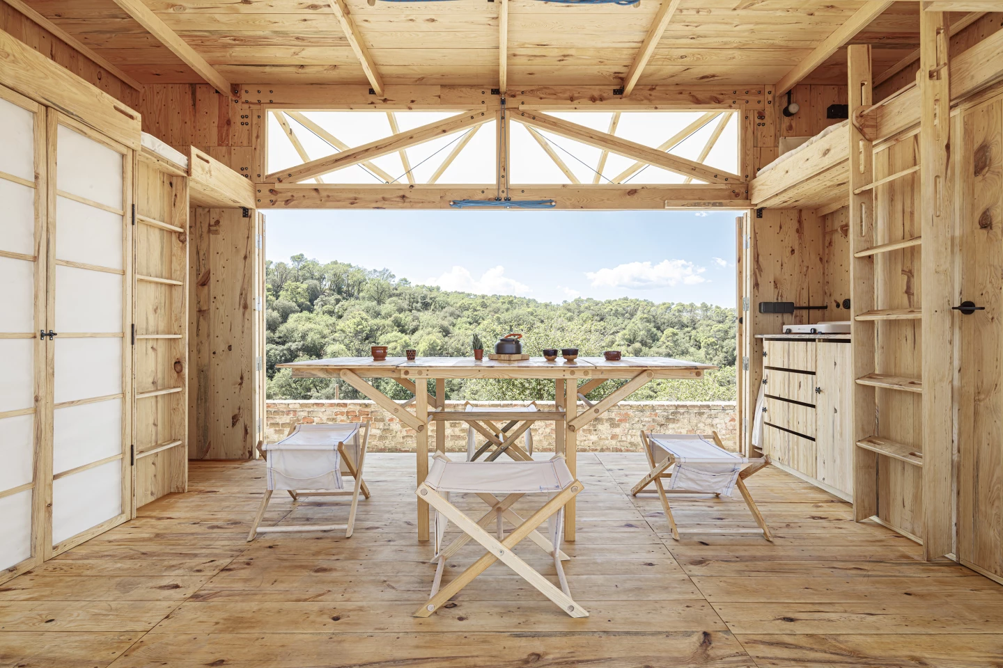 The MO.CA's center is taken up by an open living area that contains a table and chairs
