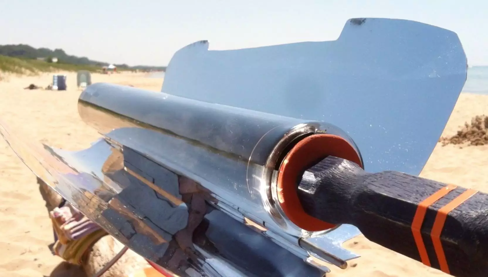 The stove also includes a sliding tray with a heat-resistant handle, allowing cooks to add or remove food at any time