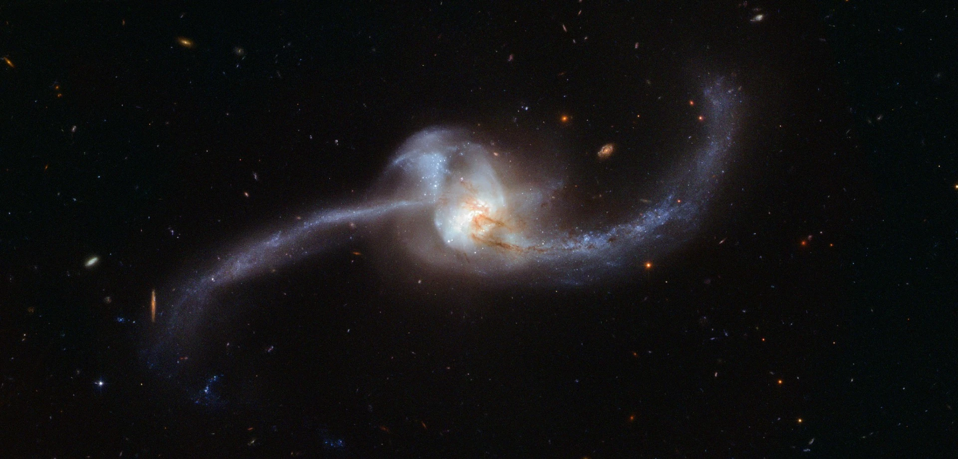 This image, captured by the NASA/ESA Hubble Space Telescope, shows what happens when two galaxies become one – the twisted cosmic knot seen here is NGC 2623 (or Arp 243) and is located about 250 million light-years away in the constellation of Cancer