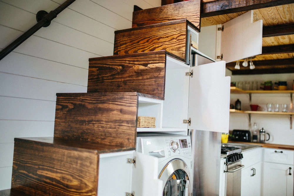 The stairs also include a washer/dryer, fridge, and cupboard space