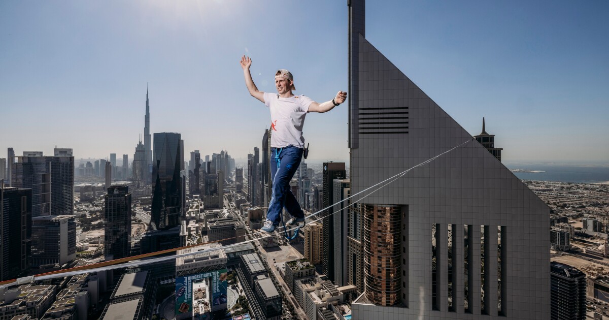 Daredevil takes a stroll between two towers at a height of over 700 ft
