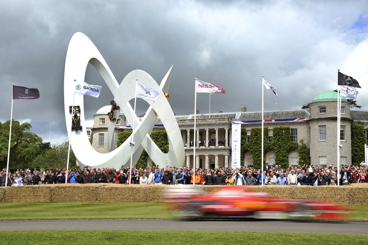 Ferrari F60 Forumla 1 car speeds past Goodwood house at the 2012 Festival of Speed