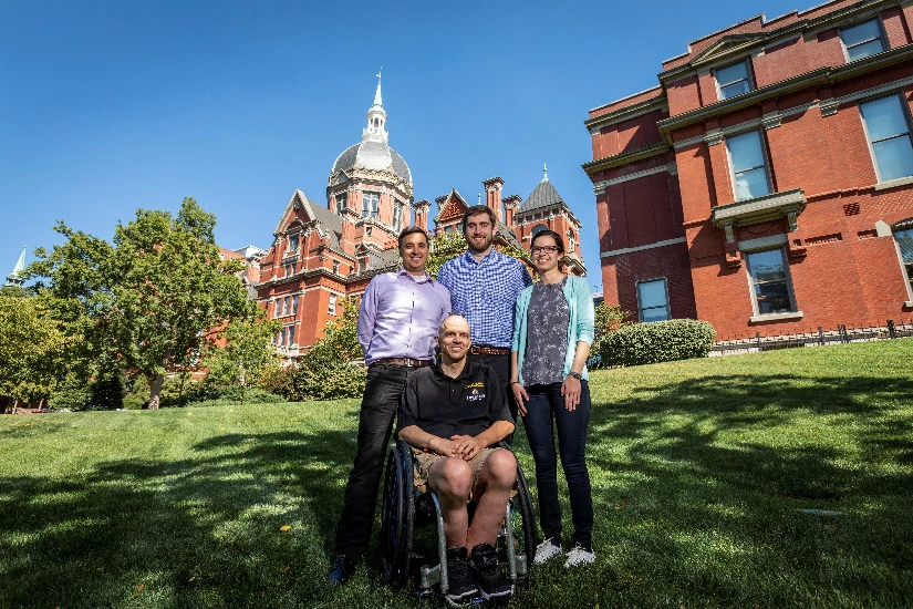 Spinal cord injury patient Buz Chmielewsk with the Johns Hopkins University research team