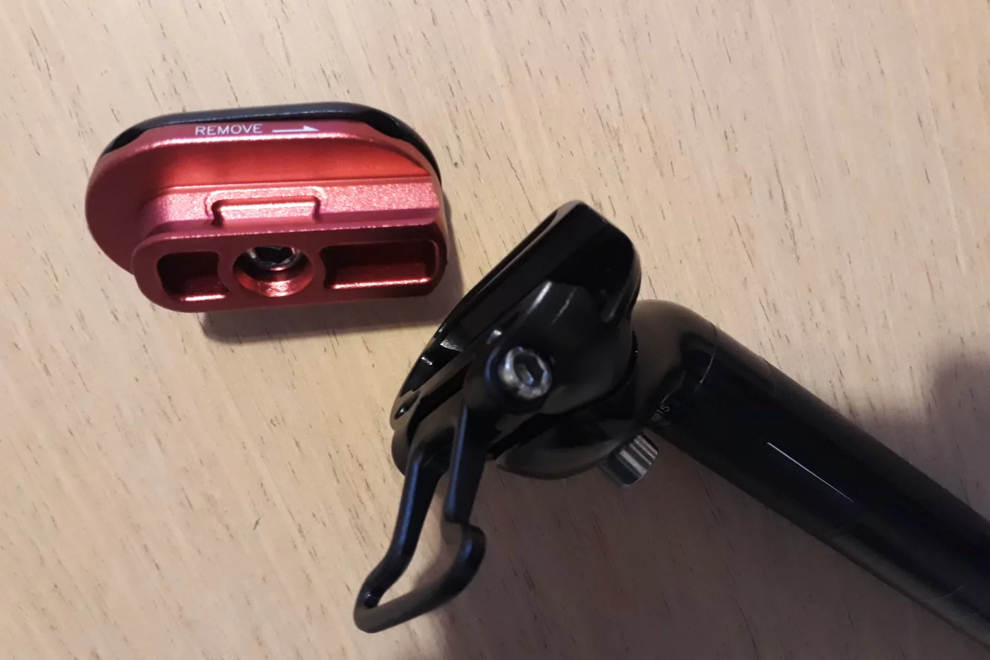 The top section (red) of the Quick Release Seatpost is clamped to the saddle rails, and quickly engages the bottom section (black) that is attached to the seatpost itself