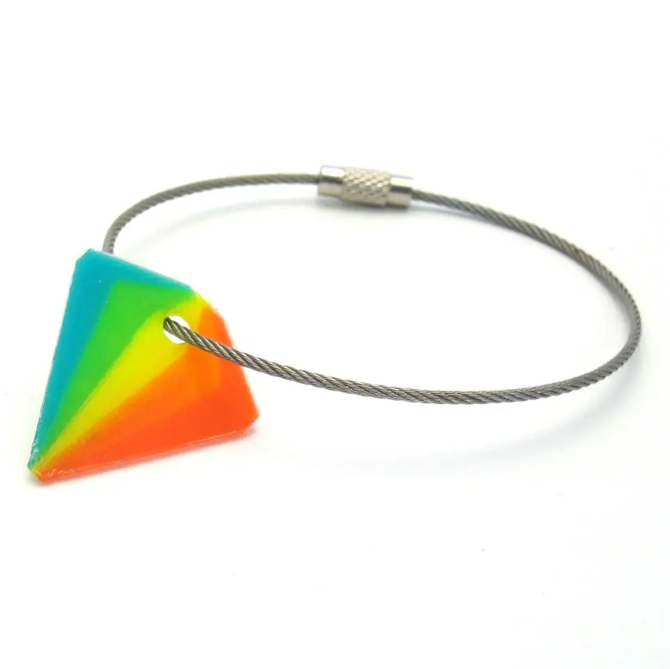 A keychain pendant in rainbow colors printed with the Diamond Hotend