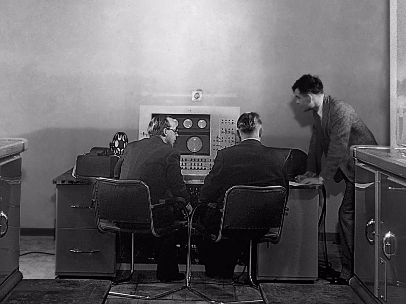 Turing (right) at the console of the Ferranti Mark I