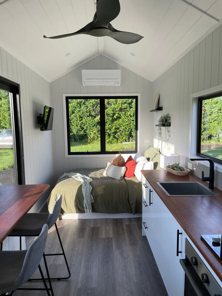 The Sierra Tiny Home's double bed also functions as a day bed/living area
