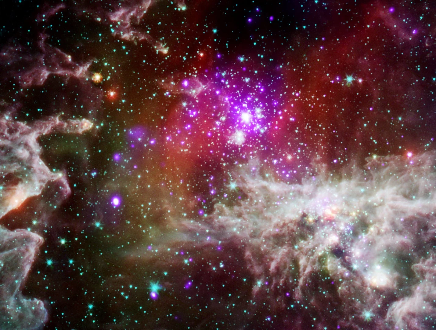 This composite image of NGC 281 – informally known as the Pacman Nebula – is made up of X-ray data from Chandra (purple) and infrared date from Spitzer (red, green and blue).