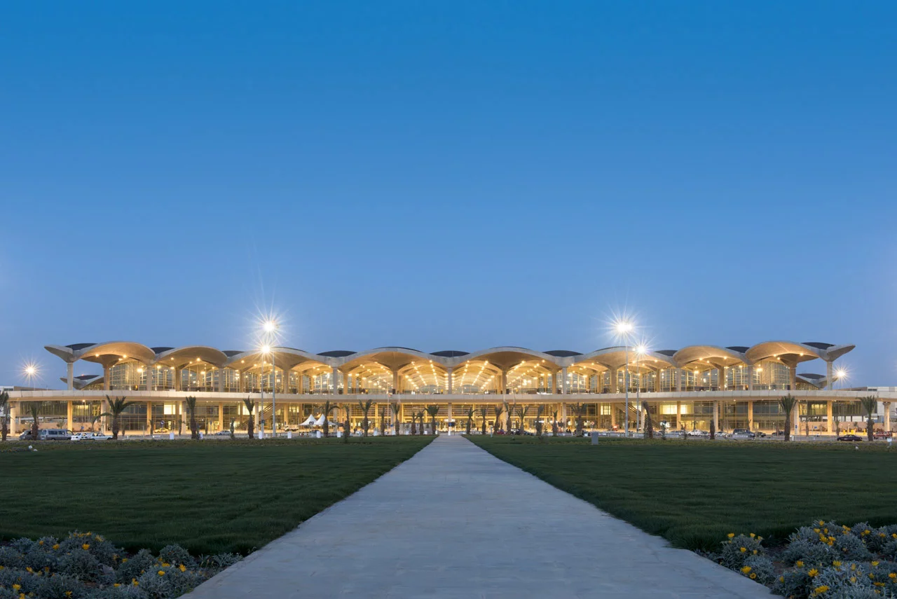 Several open-air courtyards are in between these sections, teeming with vegetation that filters nearby pollution and reflecting pools that redirect natural light into the building's transparent outer walls