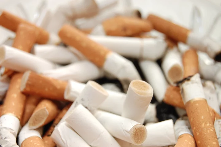 Discarded cigarette butts could soon be locked away inside asphalt roads and paths
