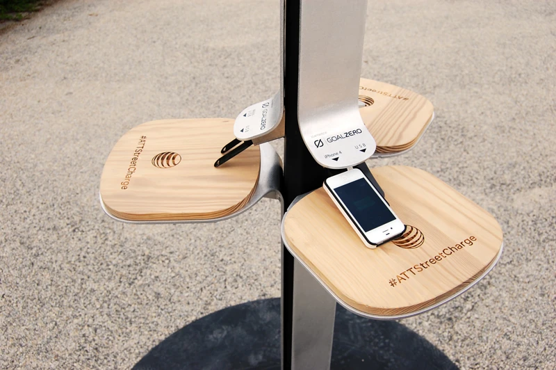 At roughly standing height, small wooden-topped shelf tables fan out from the center