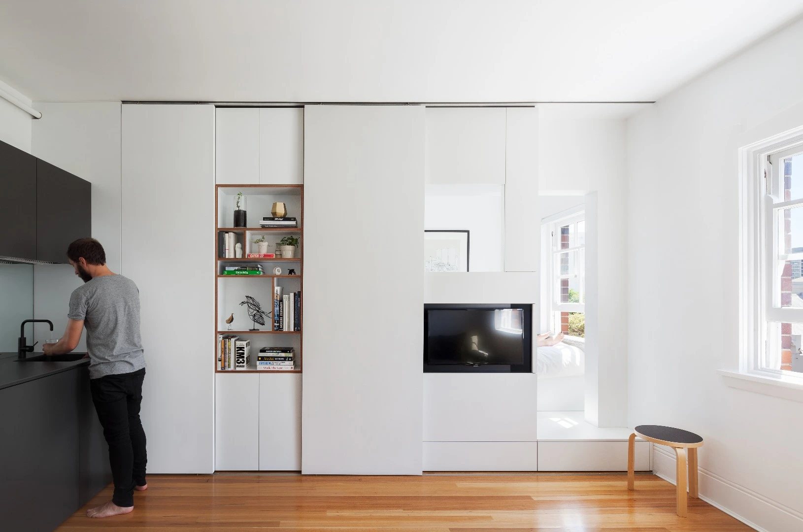 The tiny apartment features ample storage space, multi-purpose zones, clean lines and lots of natural light