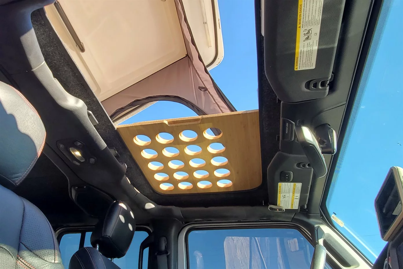 The Two Track Jeep pop-top uses the Wrangler's open roof as its access hatch