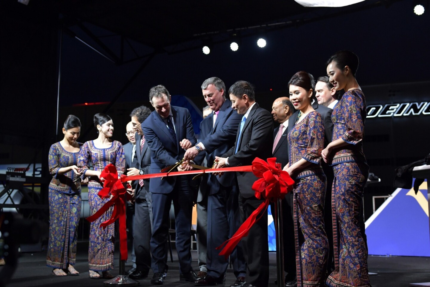 (From center left to right) Dominic Horwood, Director Customers and Services for Civil Aerospace, Kevin McAllister, President and Chief Executive Officer of Boeing Commercial Airplanes, and Goh Choon Phong, CEO, Singapore Airlines are seen here cutting a ceremonial ribbon to celebrate