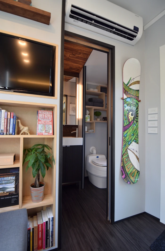 The bathroom is accessed via a small pocket door