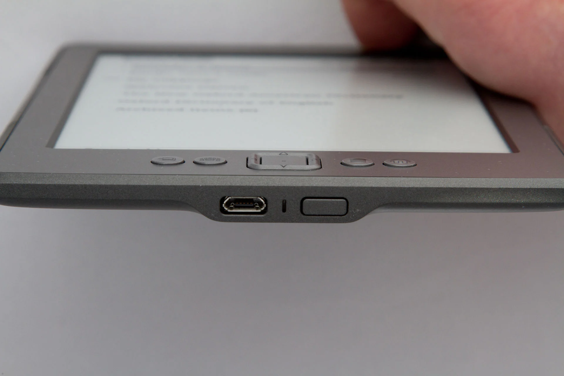 micro-B USB port and power button on the bottom of the 2011 Kindle