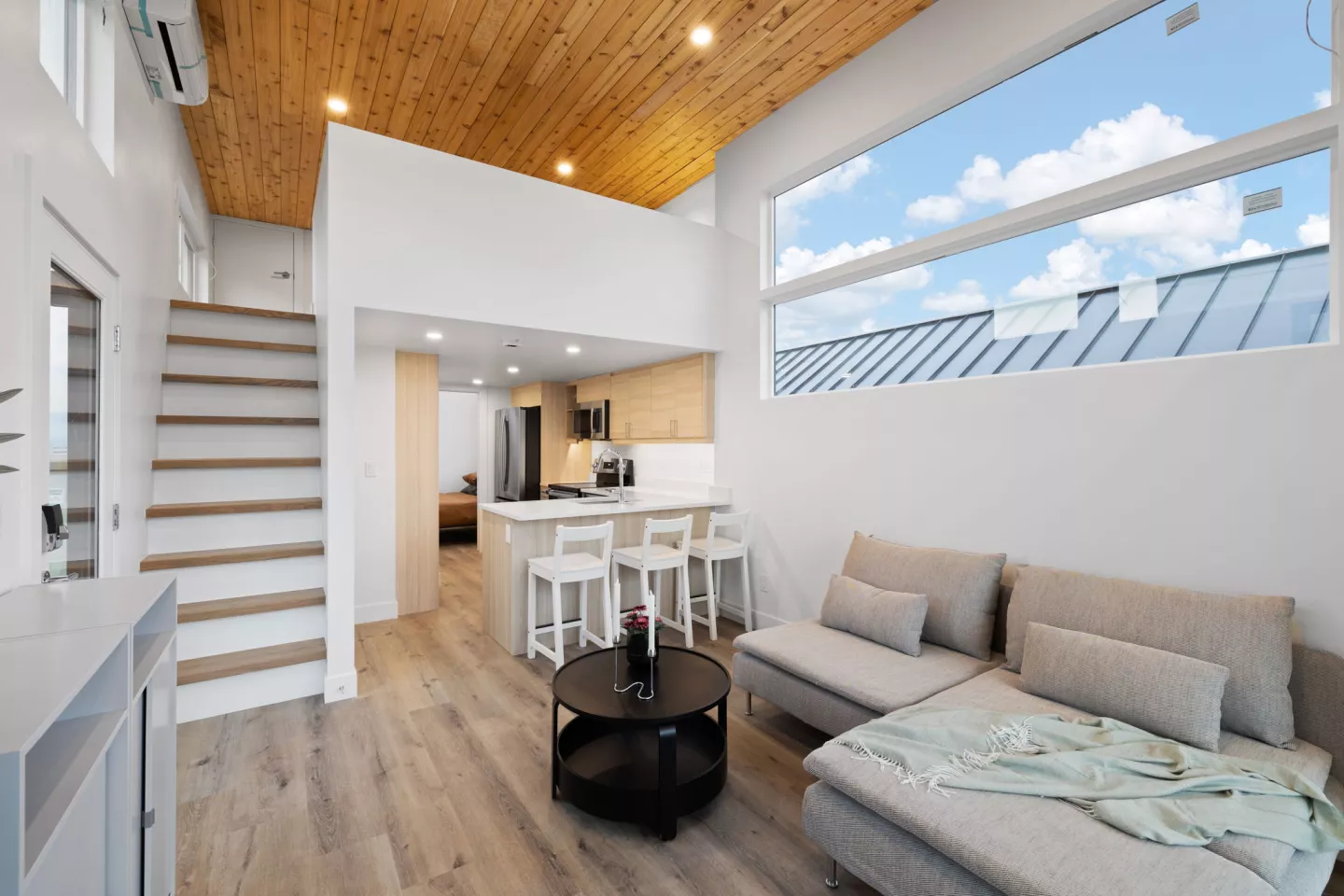 The Skyview 400's living room includes a sofa and an entertainment center, plus a small coffee table