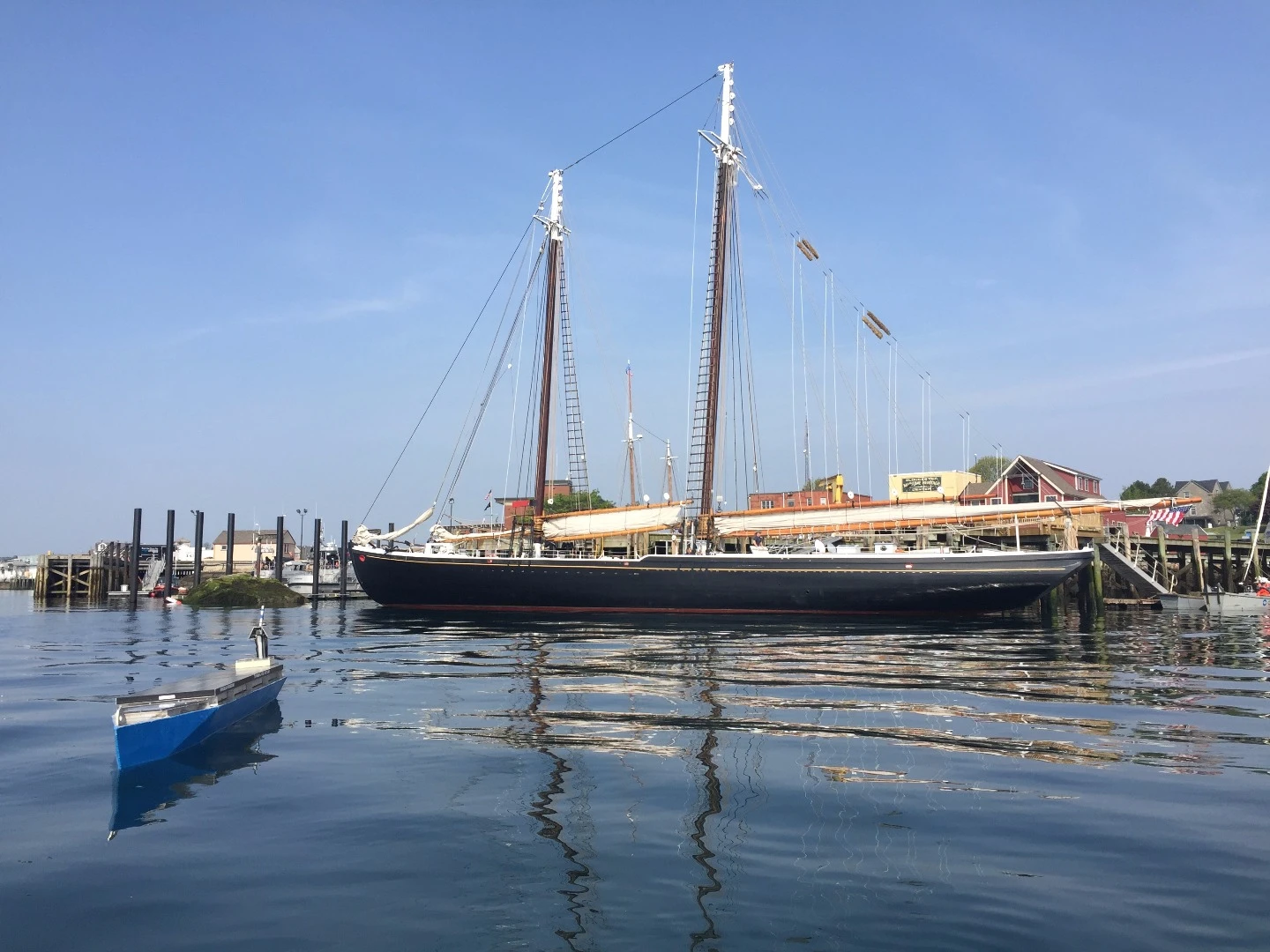 Solar Voyager in the water at Gloucester, MA, alongside The Adventure schooner