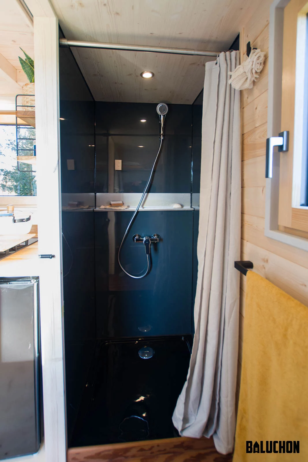 La Maison du Bonheur's bathroom looks quite snug but contains a shower and a toilet