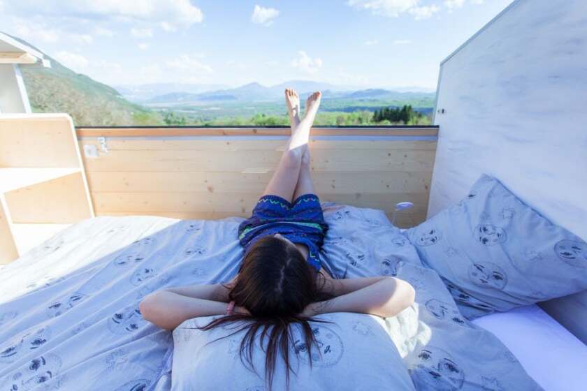 La Tête dans les étoiles' loft bedroom is a typical tiny house style but with one exception: the roof slides open