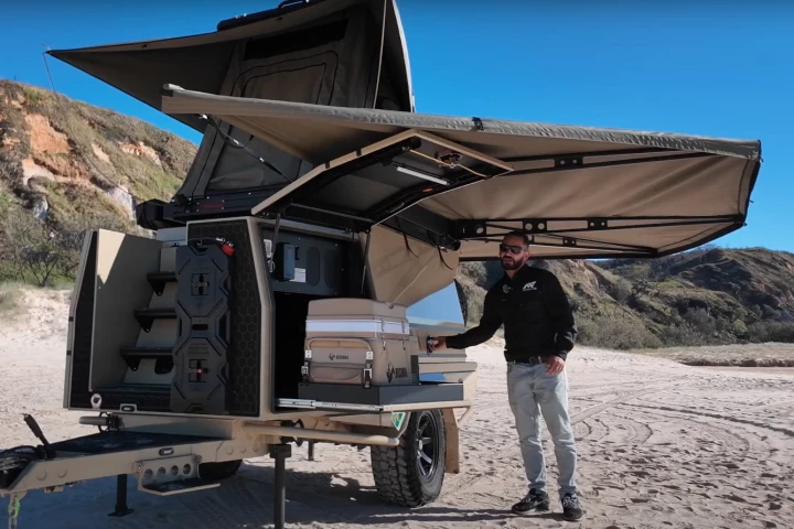 The frontmost storage hatch on the left side of travel has a slide-out fridge drawer down low, the heating system above