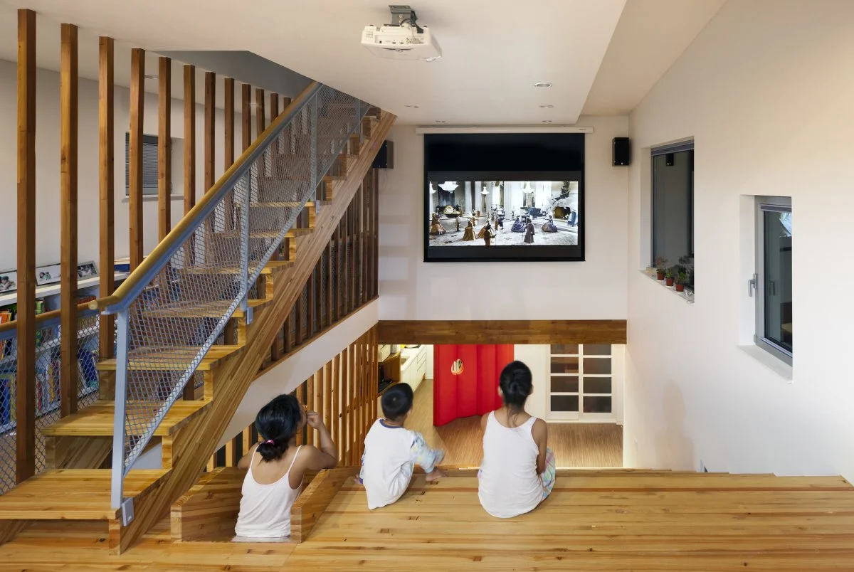 With a projector screen mounted on the wall the staircase becomes a home cinema
