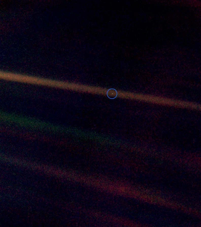 This image is known as the "Pale Blue Dot" and shows the Earth from the furthest vantage point ever – 3.7 billion miles away