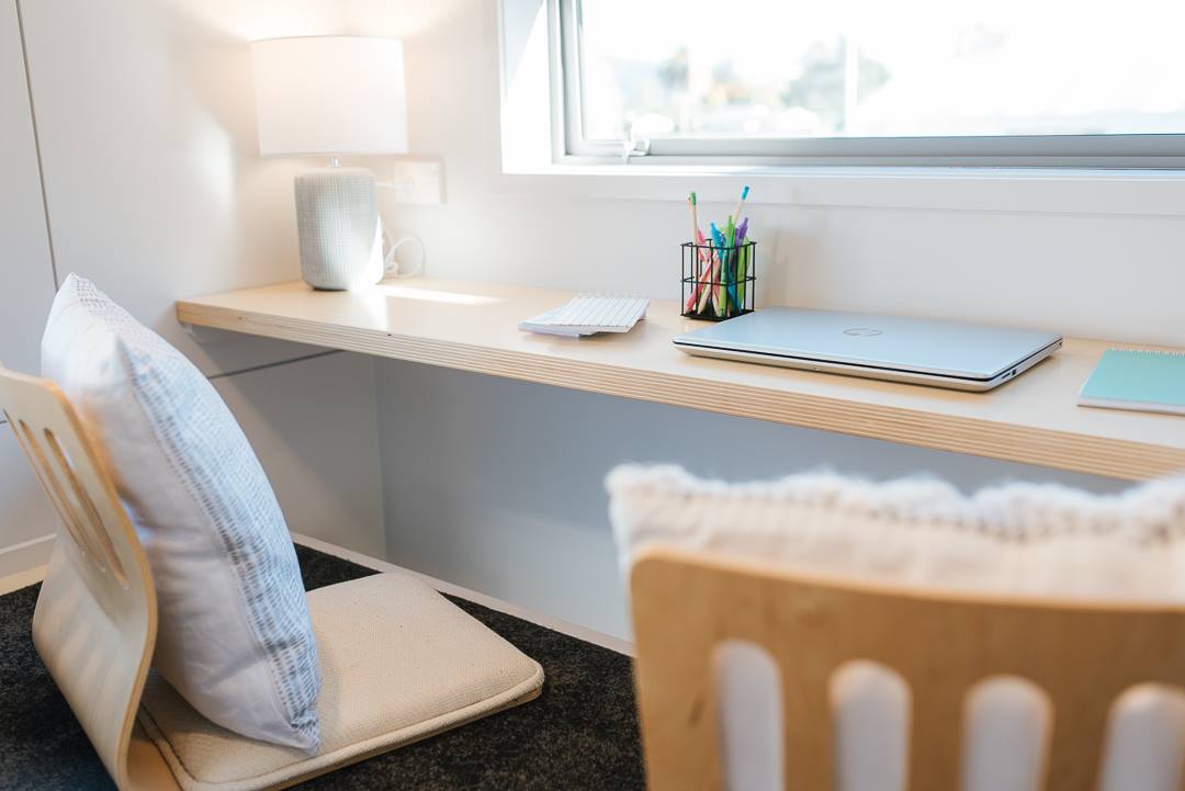 The Larissa and Tyler Tiny House's office has room for the legs to dangle, making for a more comfortable workspace