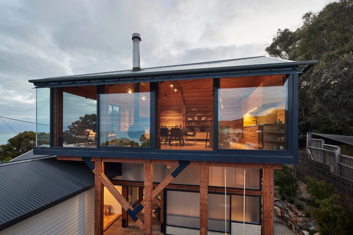 Austin Maynard Architects crafted a timber box partly over the old shack but leaving the older home untouched