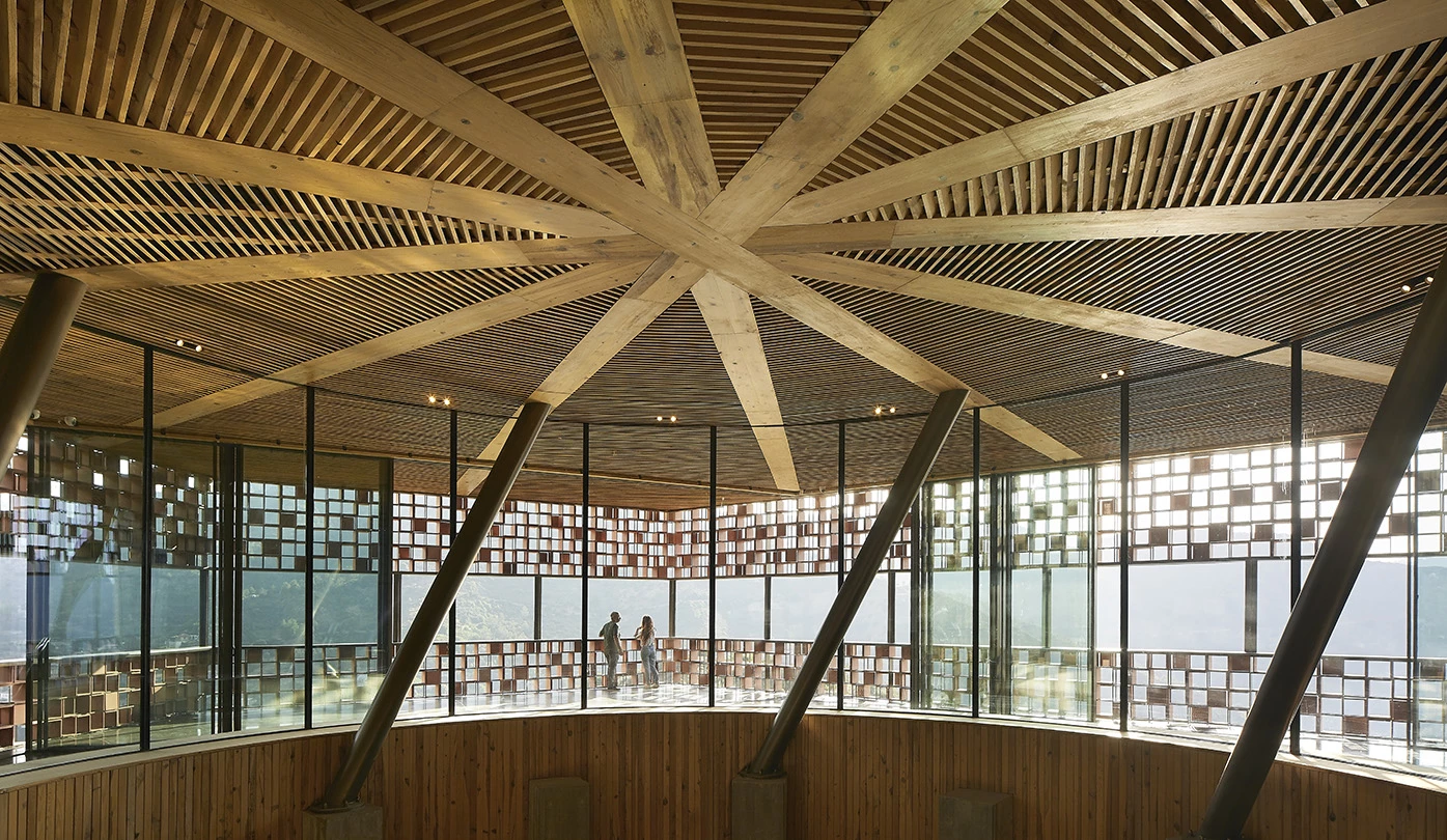 A giant geometric circular ceiling creates a centerpiece of the distillery