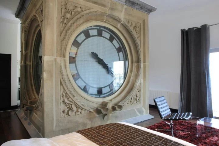 A Japanese artist has built a fully-furnished hotel room around the top to the historic Ghent Sint-Pieters station clock tower in Belgium