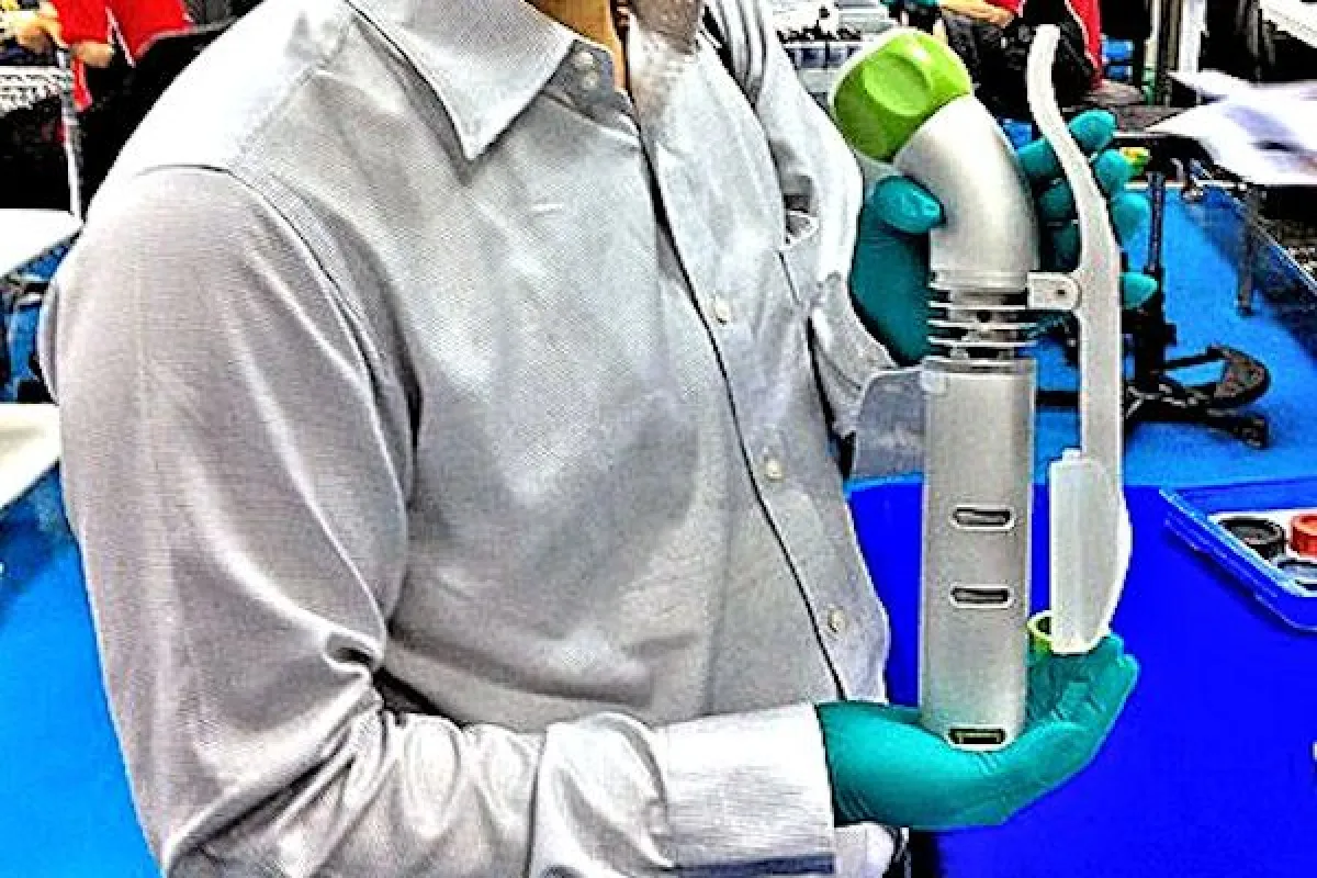 A Nomiku immersion circulator held by one of the designers