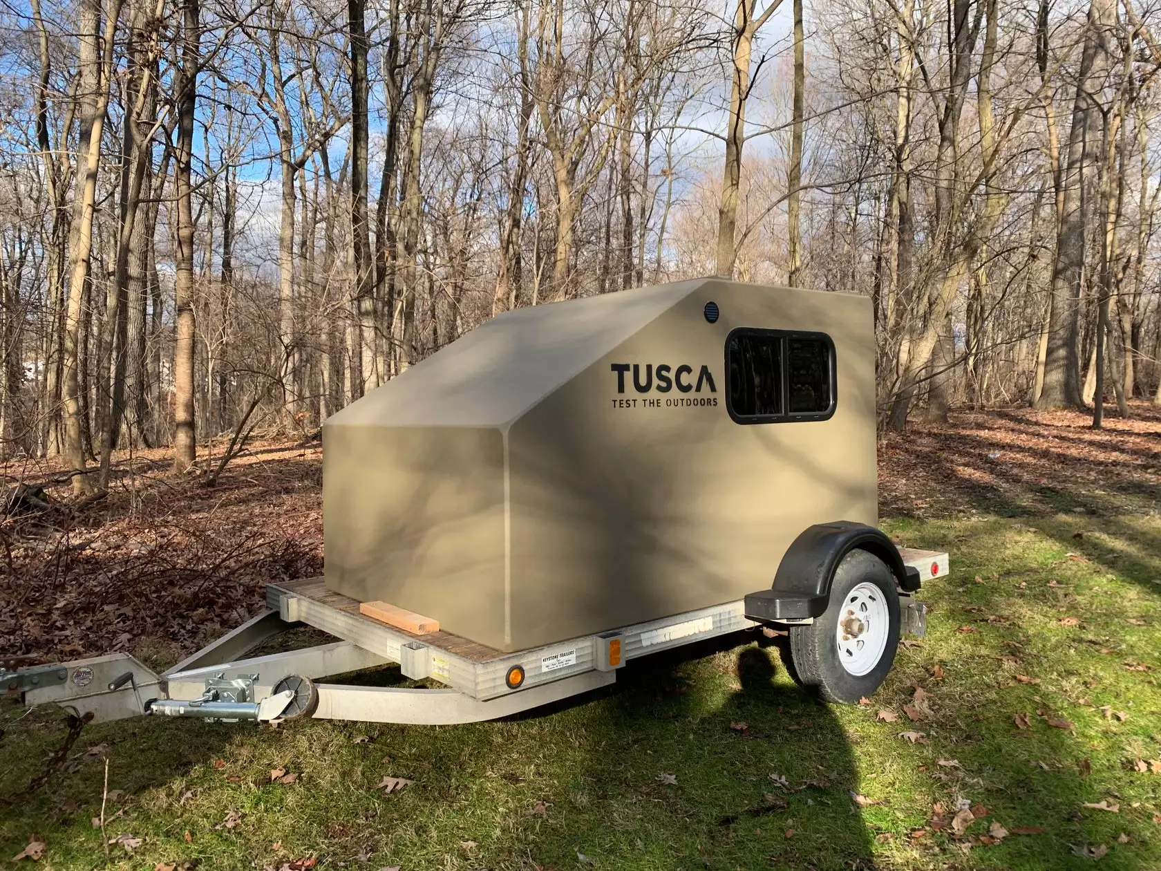 Drop it on a basic utility trailer, and the Tusca HitchHiker becomes a simple squaredrop camper