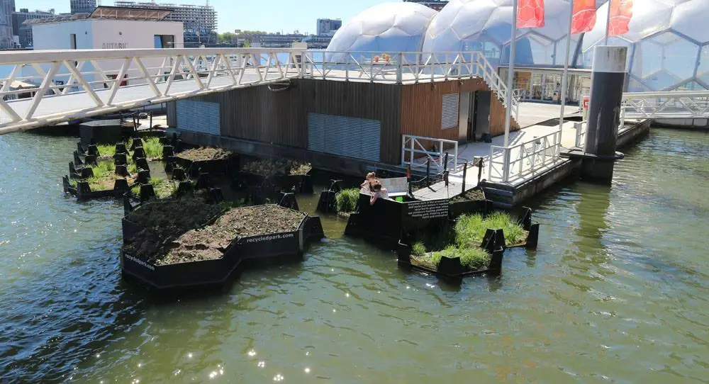 The Recycled Park's floating blocks were bolted together in a visually-pleasing pattern and moored in the harbor before being planted with greenery