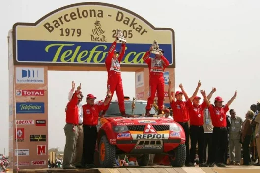 The Mitsubishi team celebrates at the finish.